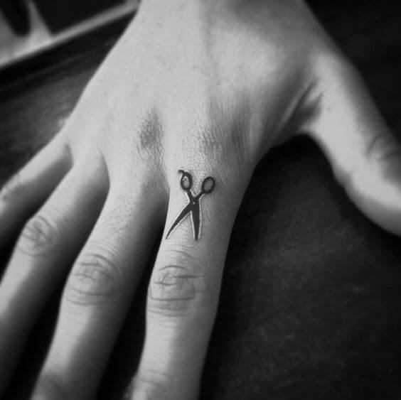 Minimalist scissor finger tattoo
