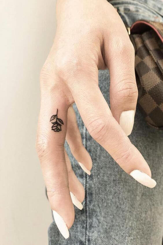 small black rose finger tattoo
