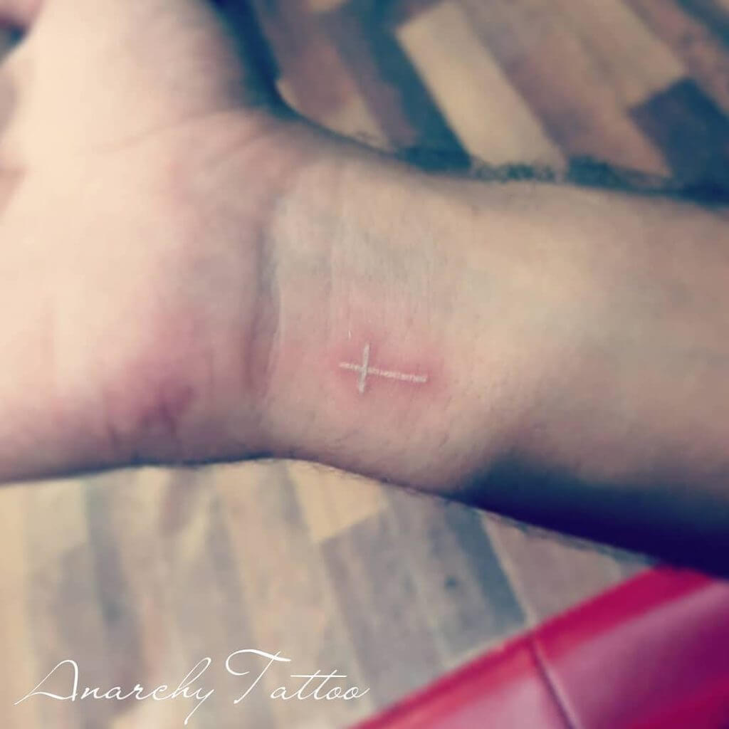 cross tattoo with white ink