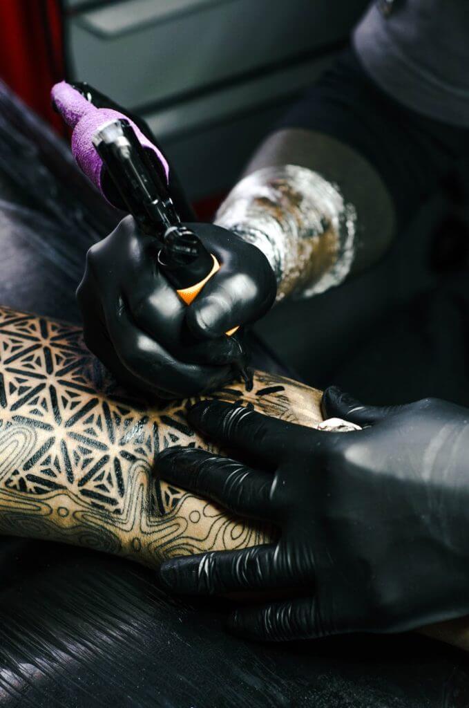 tattoo artist on work
