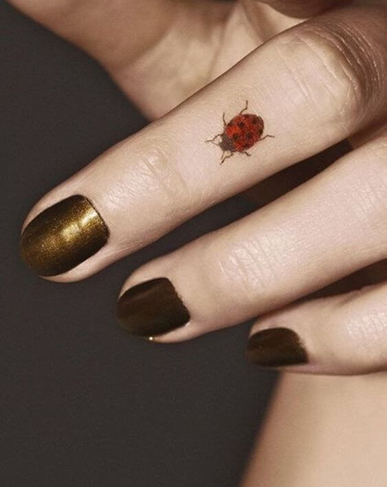 ladybugs tattoo on finger