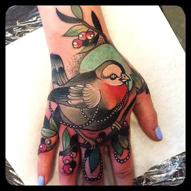neo traditional bird tattoo on hand