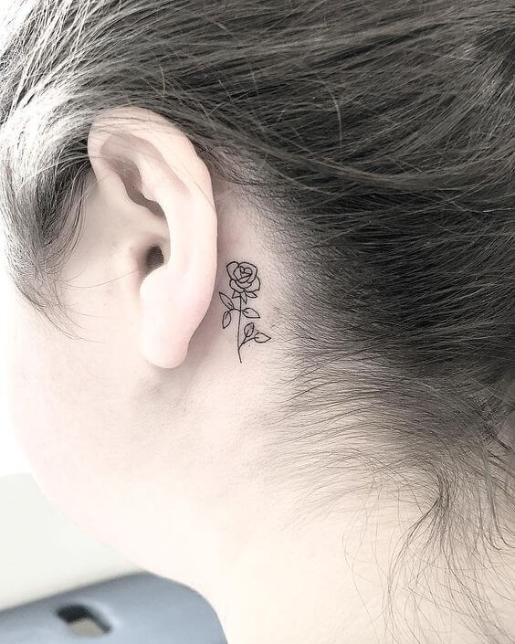 rose behind the ear tattoo
