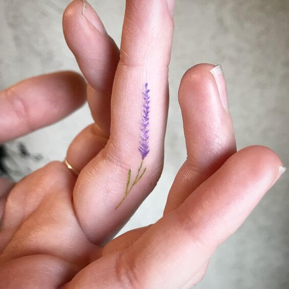 small flower hand tattoo
