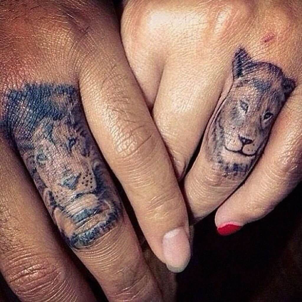 Lion and lioness finger tattoo