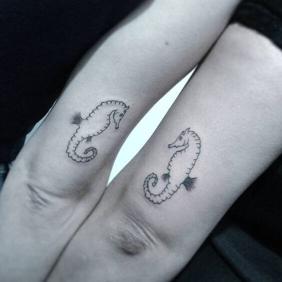 Matching seahorses tattoo