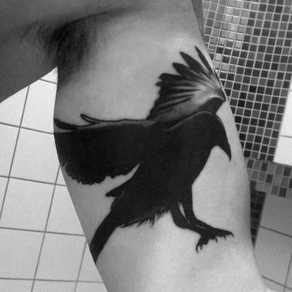 Raven tattoo in bicep