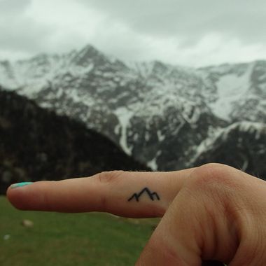 Tiny mountain draw tattoo on finger