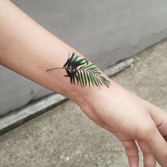 small leaf on wrist tattoo