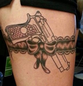gun tattoo on belt line