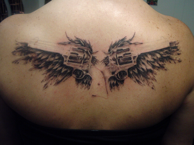 gun tattoo with wing tattoo