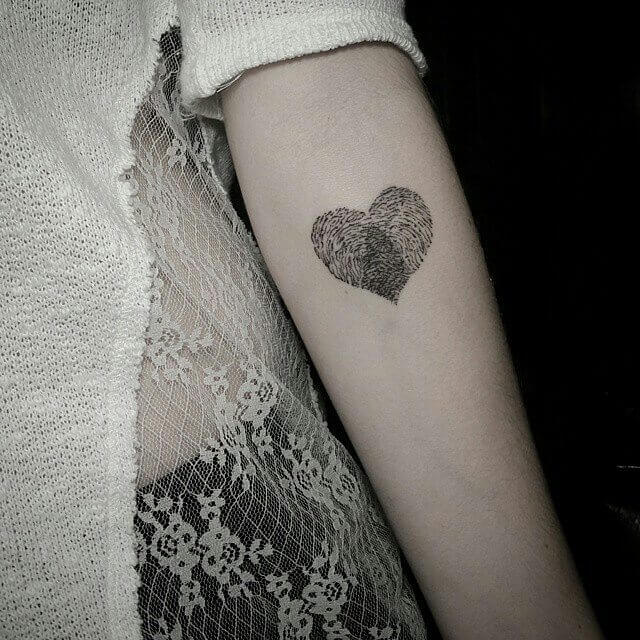 small heart shaped thumbprint tattoo