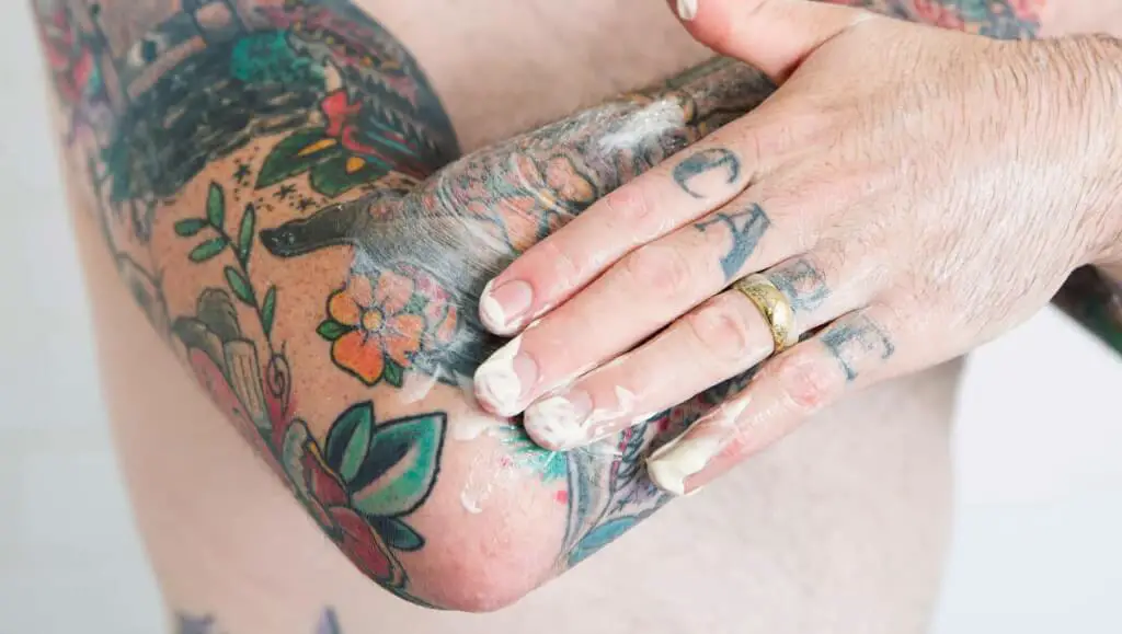 Tattoo aftercare cream application