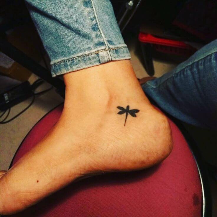 small dragonfly tattoo on foot