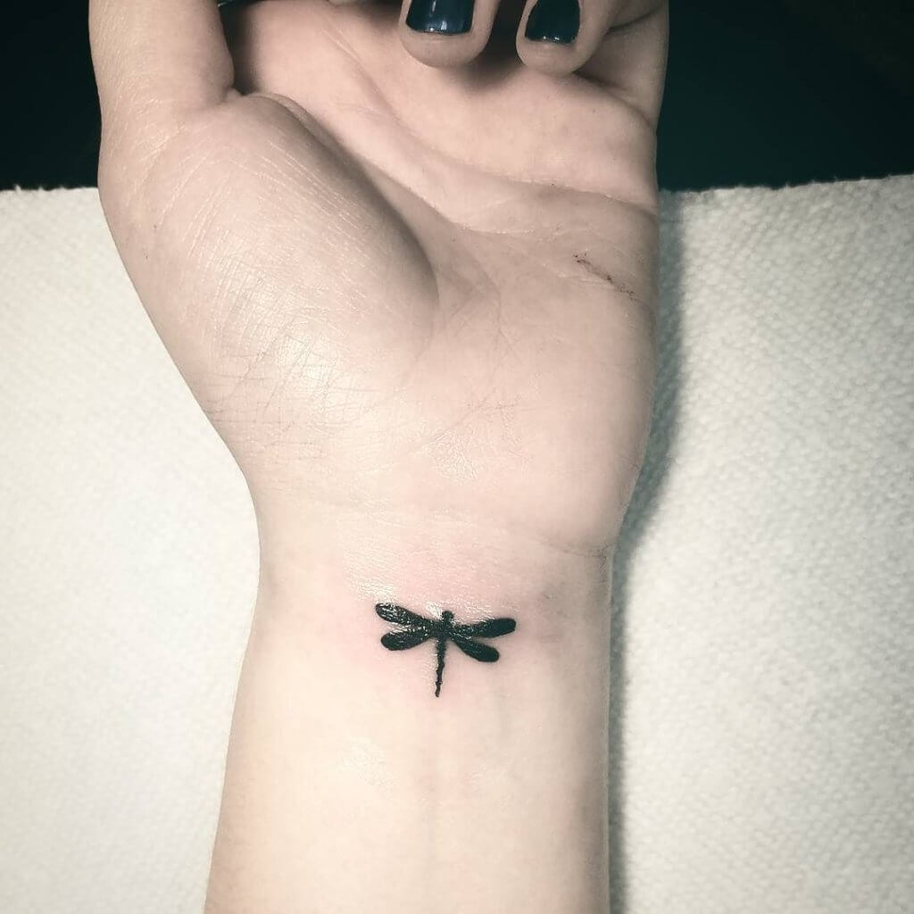 small dragonfly tattoo on wrist
